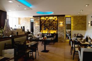 a restaurant with tables and chairs and a bar at Konoba in Meckenheim