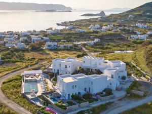 an aerial view of a white villa with the ocean at Milos Breeze Boutique Hotel in Pollonia