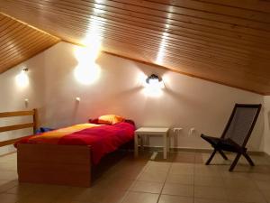 a bedroom with a bed and a chair and lights at Casa Trinta - Praia da Arrifana in Praia da Arrifana