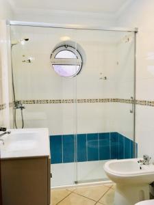 a bathroom with a shower and a sink and a toilet at Casa Trinta - Praia da Arrifana in Praia da Arrifana