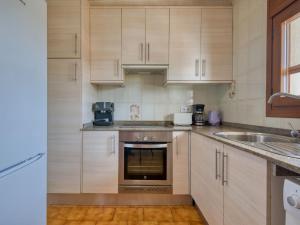 a kitchen with white cabinets and a sink at Holiday Home Montanar Plus-1 by Interhome in Jávea