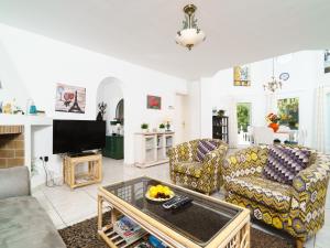 a living room with two couches and a tv at Holiday Home Montemar by Interhome in Fanadix