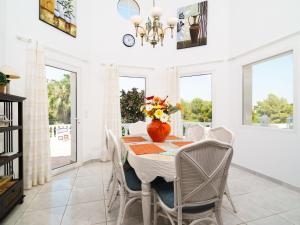 a dining room with a table with chairs and a vase of flowers at Holiday Home Montemar by Interhome in Fanadix +22 photos
