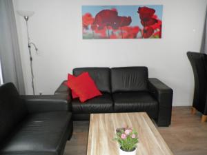 a living room with a couch and a coffee table at Holiday Home Camping Cassandria Bad-1 by Interhome in Retranchement