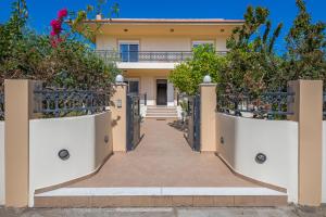 a villa with a gate in front of a house at Lina's Amazing House in Ialysos in Ixia