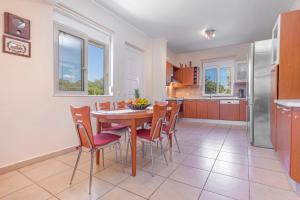 a kitchen and dining room with a table and chairs at Lina's Amazing House in Ialysos in Ixia +22 photos