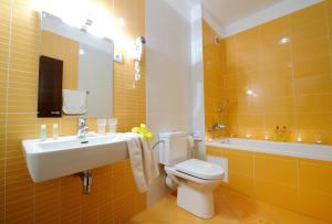 a bathroom with a white toilet and a sink at Hotel Bystricka in Martin