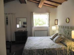 a bedroom with a large bed and a window at Vignagrande Agriturismo in Saturnia