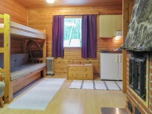 a room with a bunk bed and a kitchen at Holiday Home Lemmenliekki 3 by Interhome in Lemmenjoki