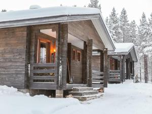 a log cabin in the snow with snow at Holiday Home Lemmenliekki 3 by Interhome in Lemmenjoki