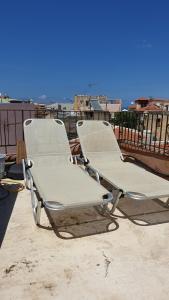 two lounge chairs sitting on top of a roof at Maro Rooms in Chania