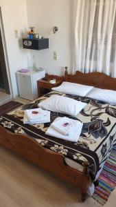 a bedroom with a wooden bed with towels on it at Maro Rooms in Chania +33 photos