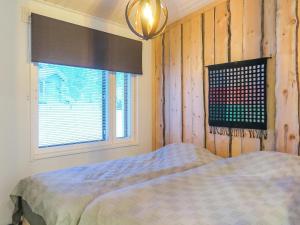 a bedroom with a bed next to a window at Holiday Home Hilla a by Interhome in Saariselka