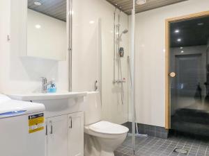 a bathroom with a shower and a toilet and a sink at Holiday Home Hilla a by Interhome in Saariselka