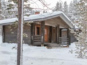 a log cabin in the snow in the woods at Holiday Home Lemmenliekki 3 by Interhome in Lemmenjoki