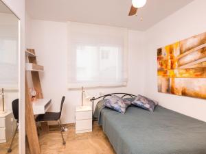 a bedroom with a bed and a desk at Apartment Reina Sofia II by Interhome in Estepona +24 photos