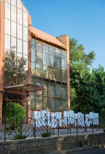 a building with a group of chairs in front of it at Helen Hotel in Mykolaiv