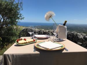 a table with two plates of food and a bottle of wine at Agriturismo Avola Antica in Avola