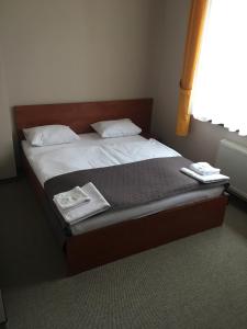 a bed in a room with two towels on it at Готель Леон in Zwiahl