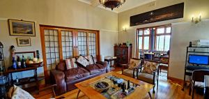 a living room with a couch and a table at Redbourne Hilldrop Guesthouse B&B in Cape Town