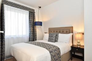 a bedroom with a large bed and a window at The Lane - Boutique Residence in Galway