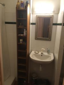 a bathroom with a sink and a mirror at Au coeur de Collioure in Collioure