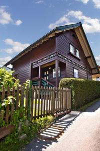 a wooden house with a fence in front of it at Ferienhaus Meissnitzer in Haus im Ennstal