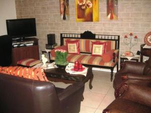 a living room with a couch and a tv at Christina Pansion in Kokkari
