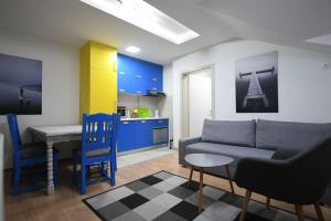 a living room with a couch and a table and a kitchen at Cozy and Lovely Appartment in Jagodina