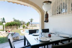 a dining table with a view of a patio at Villa Montgo Denia in Denia
