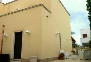 a large building with a door and a spiral staircase on it at Villa A DUE PASSI DAL MARE in Taranto