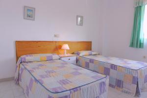 Ein Bett oder Betten in einem Zimmer der Unterkunft Torre Riviera
