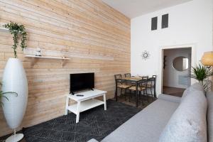 a living room with a television and a table at Cosmic by Cocoonr in Rennes