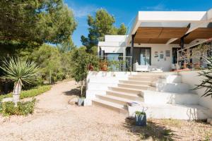a house with white stairs in front of it at Nyumba ya Sun in Cala Tarida