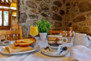 a table with a plate of bread and a cup of coffee at Hostal La Chata by Vivere Stays in La Granja de San Ildefonso