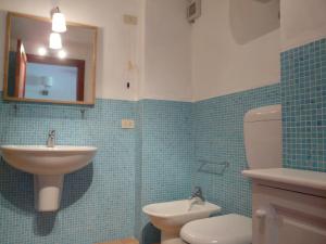 a bathroom with a sink and a toilet and a mirror at Residence Salina in Malfa