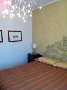 a bedroom with a bed and a chandelier at Vip Foppolo in Foppolo