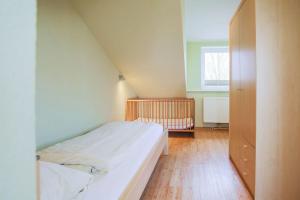 a small bedroom with a bed and a window at Buedlfarm-Nord in Sahrensdorf