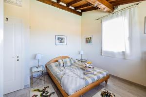 a bedroom with a bed and a window at Villa Perla con piscina by Wonderful Italy in Barcuzzi +44 photos