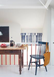 a blue chair sitting next to a wooden table at Stunning studio cntrl Totnes with parking in Totnes