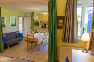 a kitchen and living room with a table and chairs at Wonderful Apartment With Great Location in Kaiserslautern