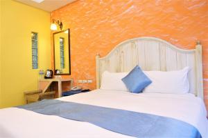 Uma cama ou camas num quarto em Yujian Kending Tese Homestay