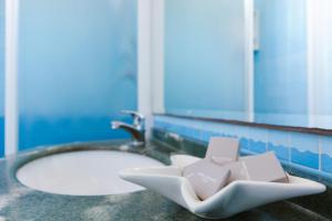 a bathroom with a sink and a mirror at Hotel Fra I Pini in Rimini