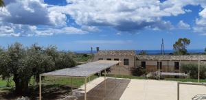 a building with a roof in front of it at Relais Casa Mirabile in Menfi