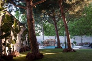 a backyard with a pool with trees and a waterfall at Hotel Puerta America in Madrid