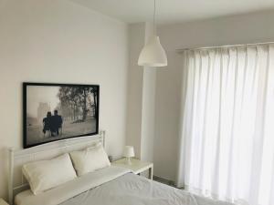 A bed or beds in a room at Korona Beach Apartments II
