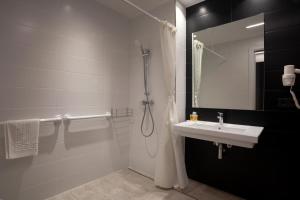 a bathroom with a sink and a shower at Tramuntana in La Jonquera