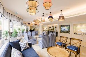 a living room with blue couches and chairs at The Albatroz Hotel in Cascais