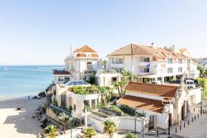 an aerial view of a house on the beach at The Albatroz Hotel in Cascais