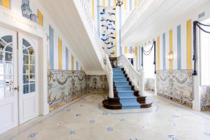 a staircase in a building with blue and yellow walls at The Albatroz Hotel in Cascais